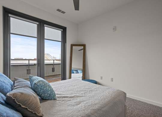 Aug Smith on Main bedroom with a large bed and a ceiling fan.