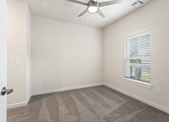 Peaks of Lexington Apartments Bedroom with Ceiling Fan, Light, Window and Gray Carpet