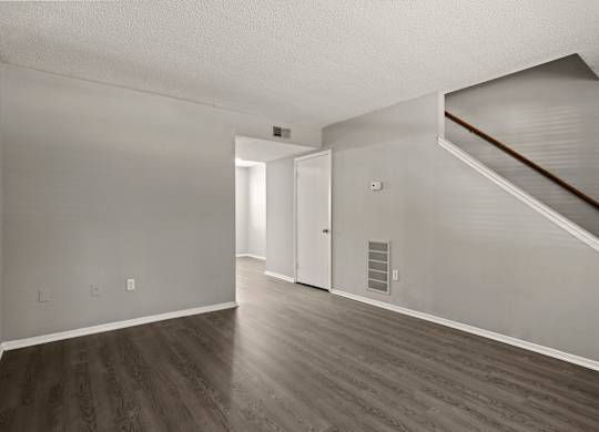 A room with a staircase and a door.