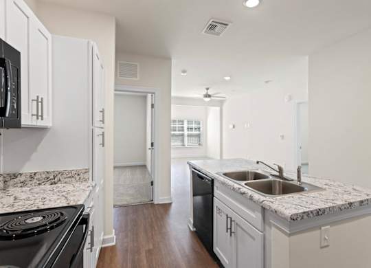 Peaks of Lexington Apartments Kitchen with Black Appliances, Granite Countertops and White Cabinetry