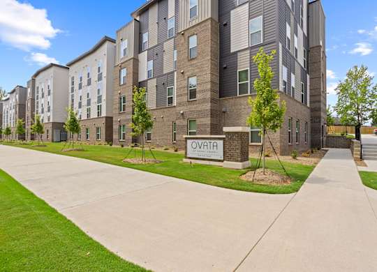 A sign that reads Ovata at Reedy Creek in front of Ovata at Reedy Creek Senior Apartments in Charlotte NC.