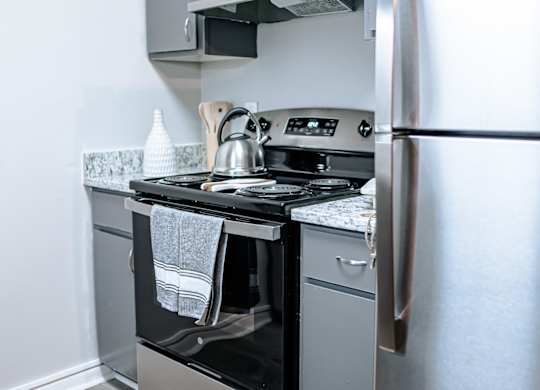 A kitchen with a stainless steel refrigerator, oven, and dishwasher.