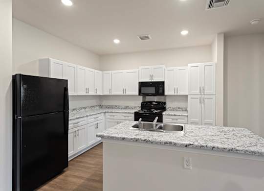 Peaks of Lexington Apartments Kitchen with Black Appliances, Granite Countertops and White Cabinetry