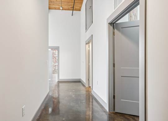 Hallway in a unit in Converse Mill Lofts in Spartanburg, SC with stone floors