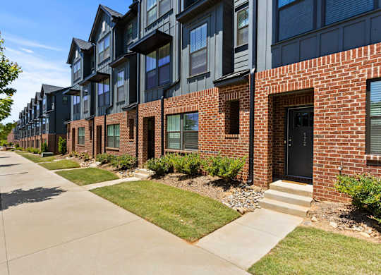 A row of modern brick and black apartment buildings.