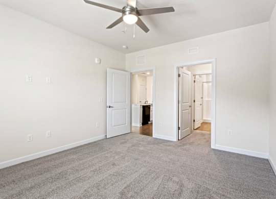 Peaks of Lexington Apartments Kitchen with Black Appliances, Granite Countertops and White Cabinetry and connected living room