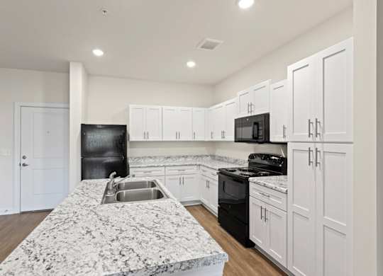 Peaks of Lexington Apartments Kitchen with Black Appliances, Granite Countertops and White Cabinetry