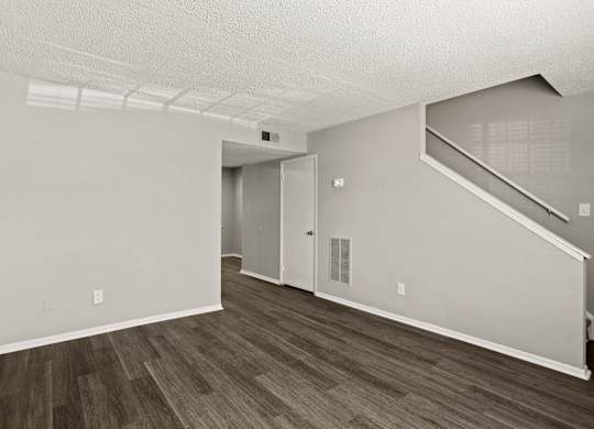 A room with a staircase and a door.