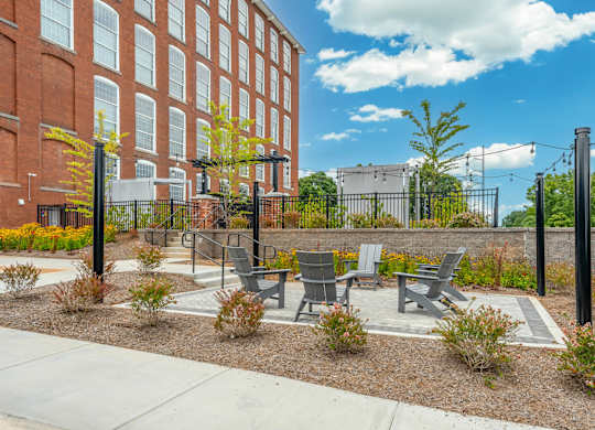 Chairs outside of the pool in Converse Mill Lofts Apartments in Spartanburg SC
