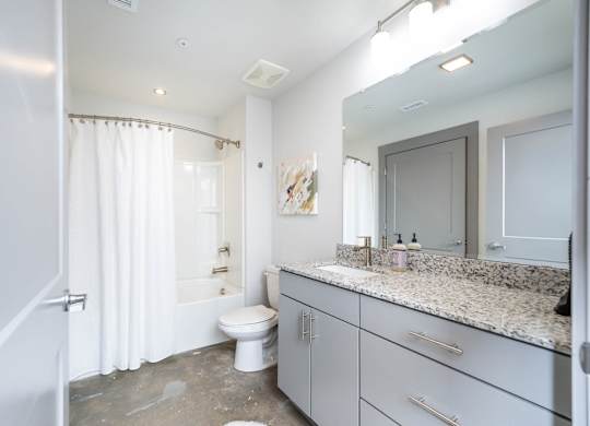 Converse Mill Lofts Luxury Apartments Bathroom with Granite Countertops