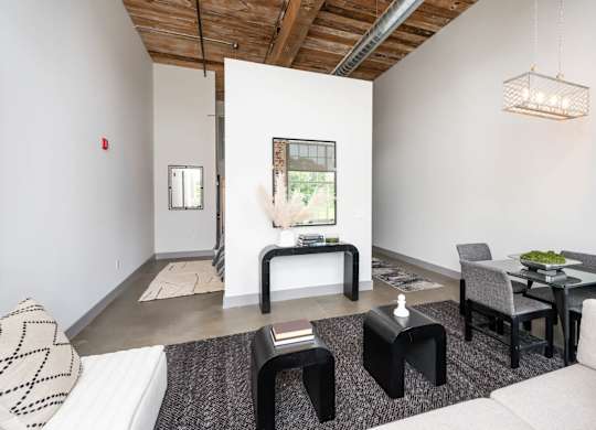 Converse Mill Lofts Luxury Apartments Model Unit Living Room with High Ceilings and Exposed Wood