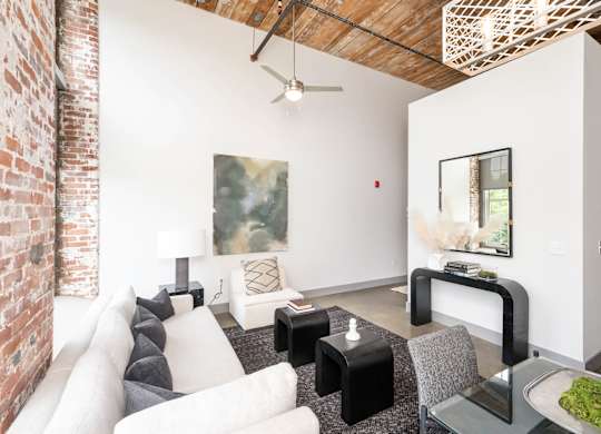Converse Mill Lofts Luxury Apartments Model Unit Living Room with High Ceilings and Exposed Wood