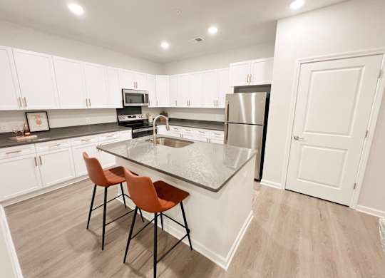 Pet-Friendly Luxury Apartments In Boiling Springs, SC - Grande At Geyser Falls - Kitchen with Island and Stainless Steel Appliances