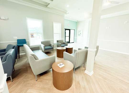 The Haven at Palmer Pointe Senior Apartments Living Room in Community Center with couches and a television