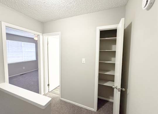 Reserve at Hillcrest upstairs with closet with shelves, a carpet, a bathroom and two bedrooms.