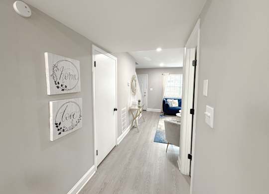 Reserve at Hillcrest furnished model unit downstairs hallway looking into living room