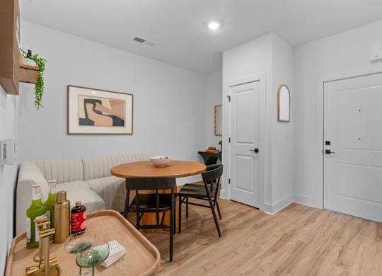 A dining area with a table and chairs.