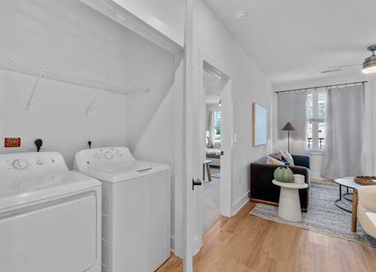 A white bathroom with a washer and dryer.