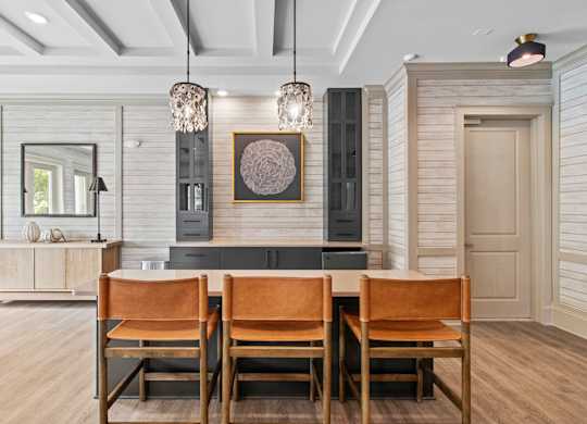 A dining room with a wooden table and chairs.