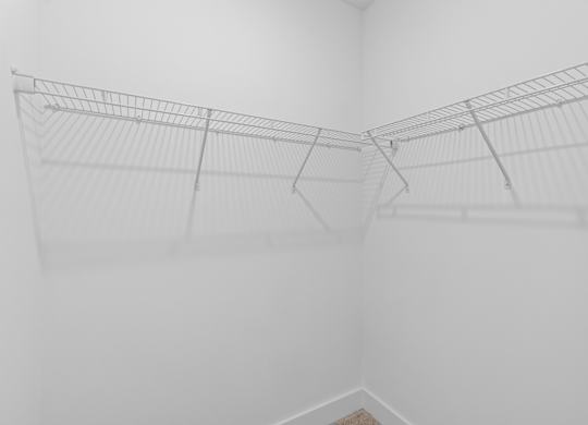 A white wire shelf in a white room.