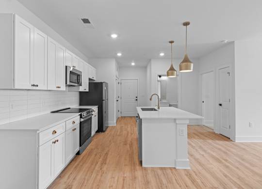 A modern kitchen with white cabinets and a black refrigerator.