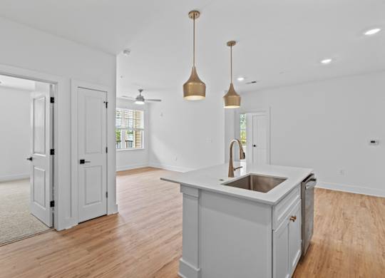 A kitchen with a sink and a counter.