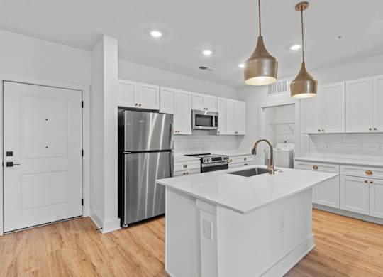 A modern kitchen with white cabinets and a central island.