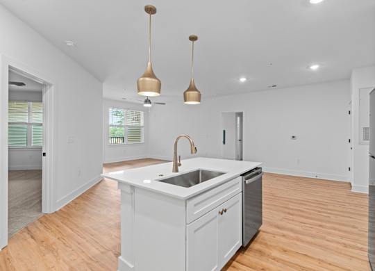 A kitchen with a white counter and a sink.