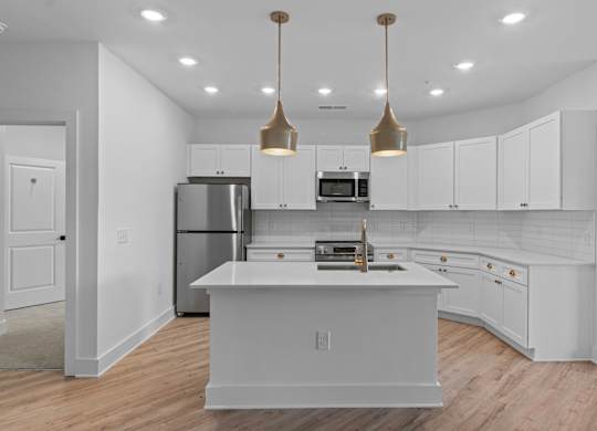 A modern kitchen with white cabinets and a central island.