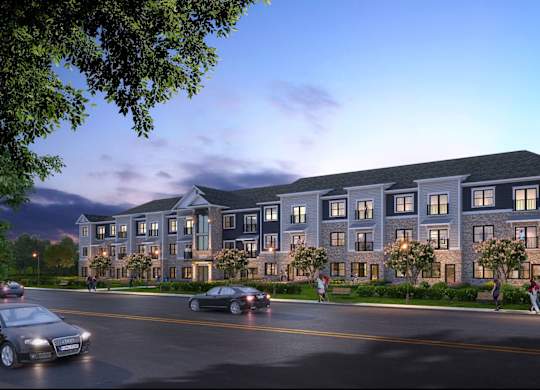 Huntersville, NC Apartments for Rent - Norman Lofts - Street View Of Property Building With Lush Greenery On The Front Lawn And Benches Along The Sidewalk.