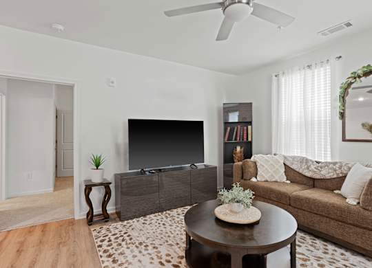 Ovata at Reedy Creek living room with luxury vinyl tile flooring and a ceiling fan