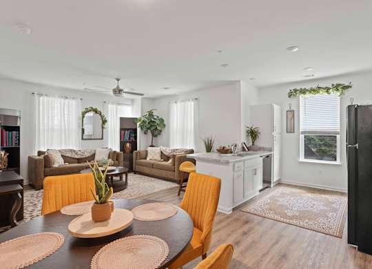 Ovata at Reedy Creek kitchen, dining room and living room with LVT, modern appliances and a ceiling fan.