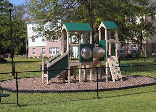 a playground with a slide and other playground equipment