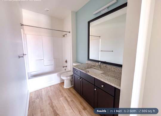A bathroom with a toilet, sink, and bathtub.