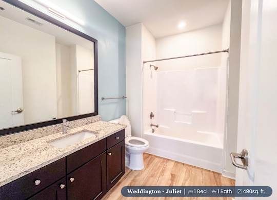 A bathroom with a sink, toilet, and bathtub.