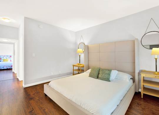A bedroom with a bed, nightstands, and a window at Twelve One Ten Rochester, California 90025
