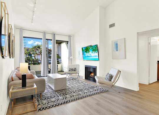 A living room with a fireplace and a television at Twelve One Ten Rochester, California