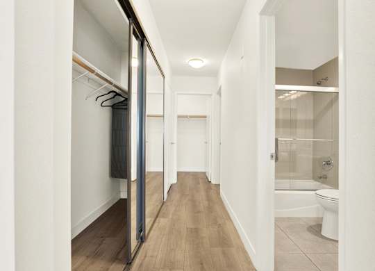 A white hallway with a toilet visible in the distance at Twelve One Ten Rochester, Los Angeles, California
