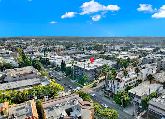 A cityscape with buildings, roads, and cars under a blue sky at Twelve One Ten Rochester, Los Angeles, CA