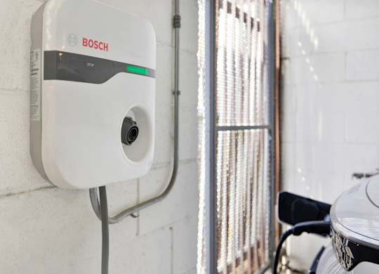 A Bosch electric vehicle charging station is mounted on a wall at Twelve One Ten Rochester, Los Angeles, 90025