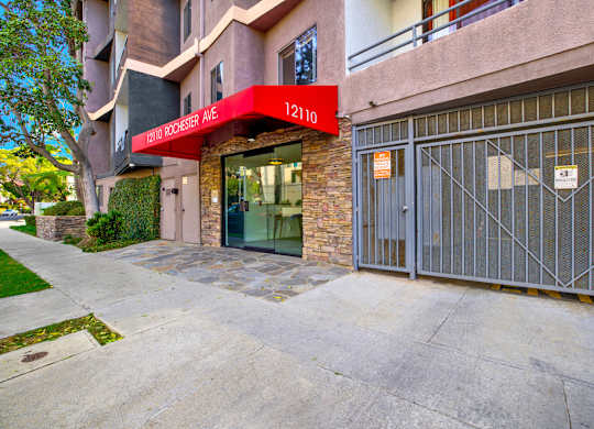 A building with a red awning that says 1210 on it at Twelve One Ten Rochester, Los Angeles, CA