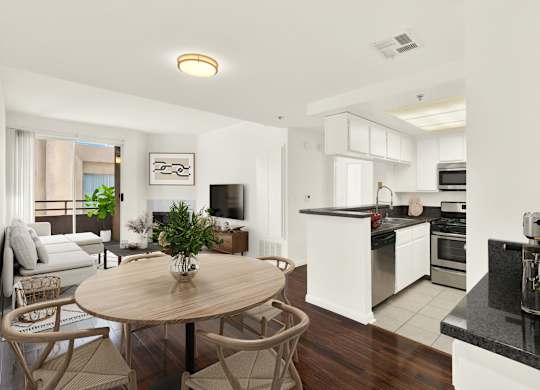 A modern kitchen with a dining table and chairs at Peach Tree Court, Los Angeles, CA 90024