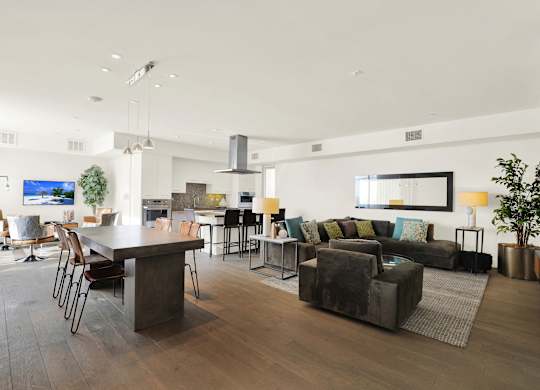 A modern living room with a dark wood floor and furniture at The Urbanpolitan, Los Angeles, California