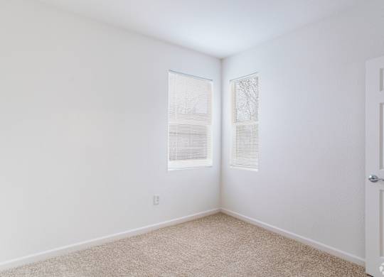 A room with a carpet floor and two windows at Cornerstone at Gale Ranch Apartments, San Ramon 94582