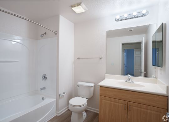 A white bathroom with a toilet, sink, and bathtub at Cornerstone at Gale Ranch Apartments, California, 94582