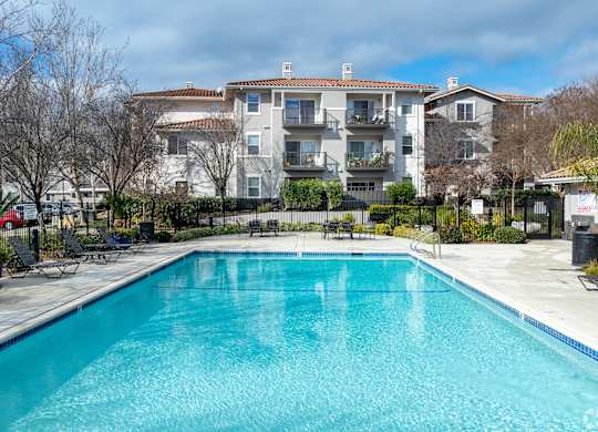 A swimming pool in front of a residential building at Cornerstone at Gale Ranch Apartments, San Ramon, CA