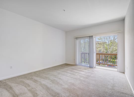 a bedroom with a sliding glass door and a carpeted floor at Cornerstone at Gale Ranch Apartments, San Ramon 94582