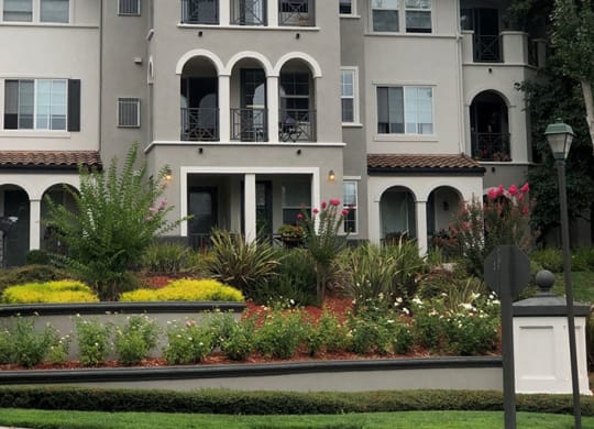 a large apartment building with a garden in front of it  at Falcon Bridge at Gale Ranch, San Ramon, California