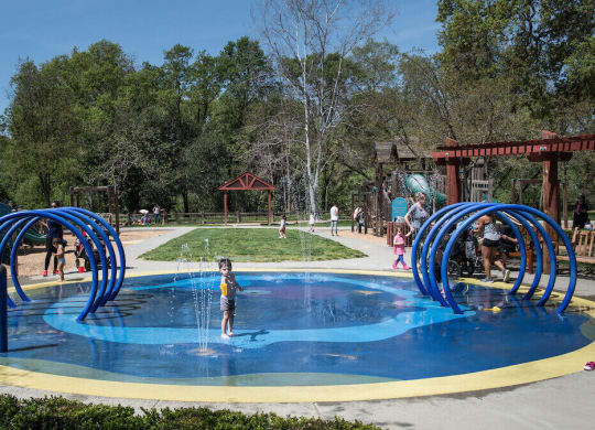 a child plays in a water park  at Falcon Bridge at Gale Ranch, San Ramon
