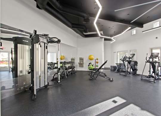 A gym with a variety of exercise equipment.